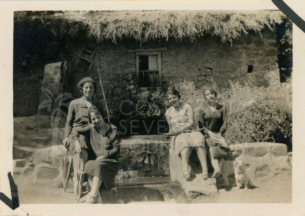 Women in front of a traditional house-pht_CP_0078