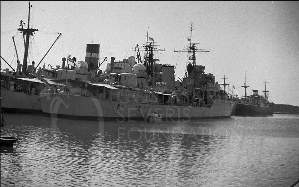 A modern (1954) warship tied up taking on rations for her next trip-pht_RC_067