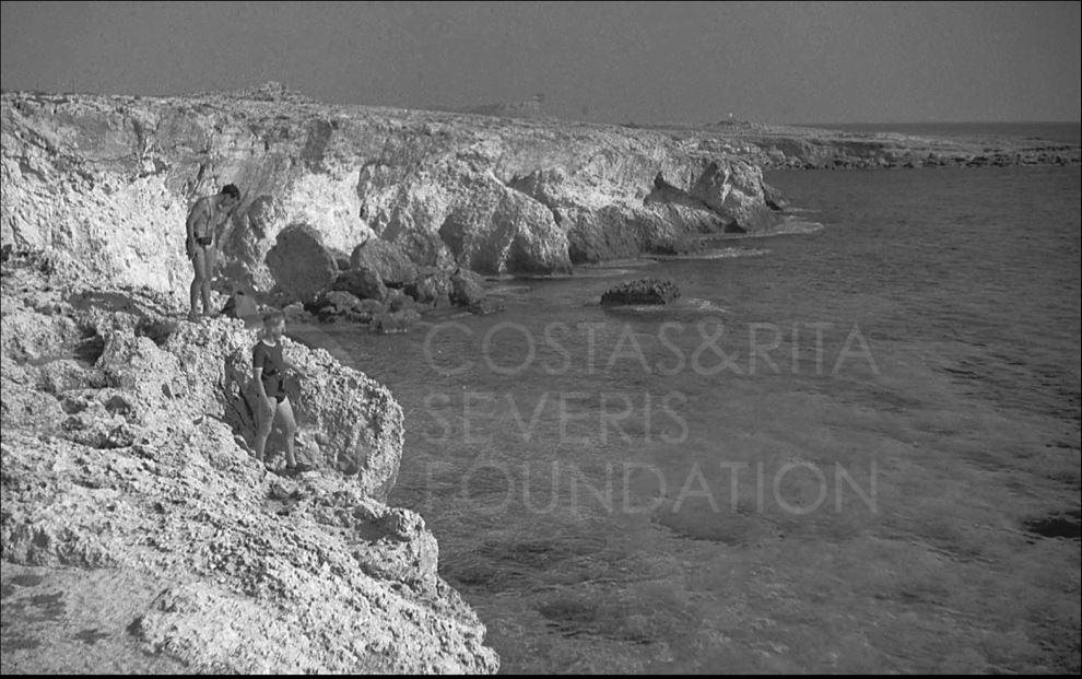 Two of the lads admire the coastline and clear blue sea and wonder whether to dive in!-pht_RC_155